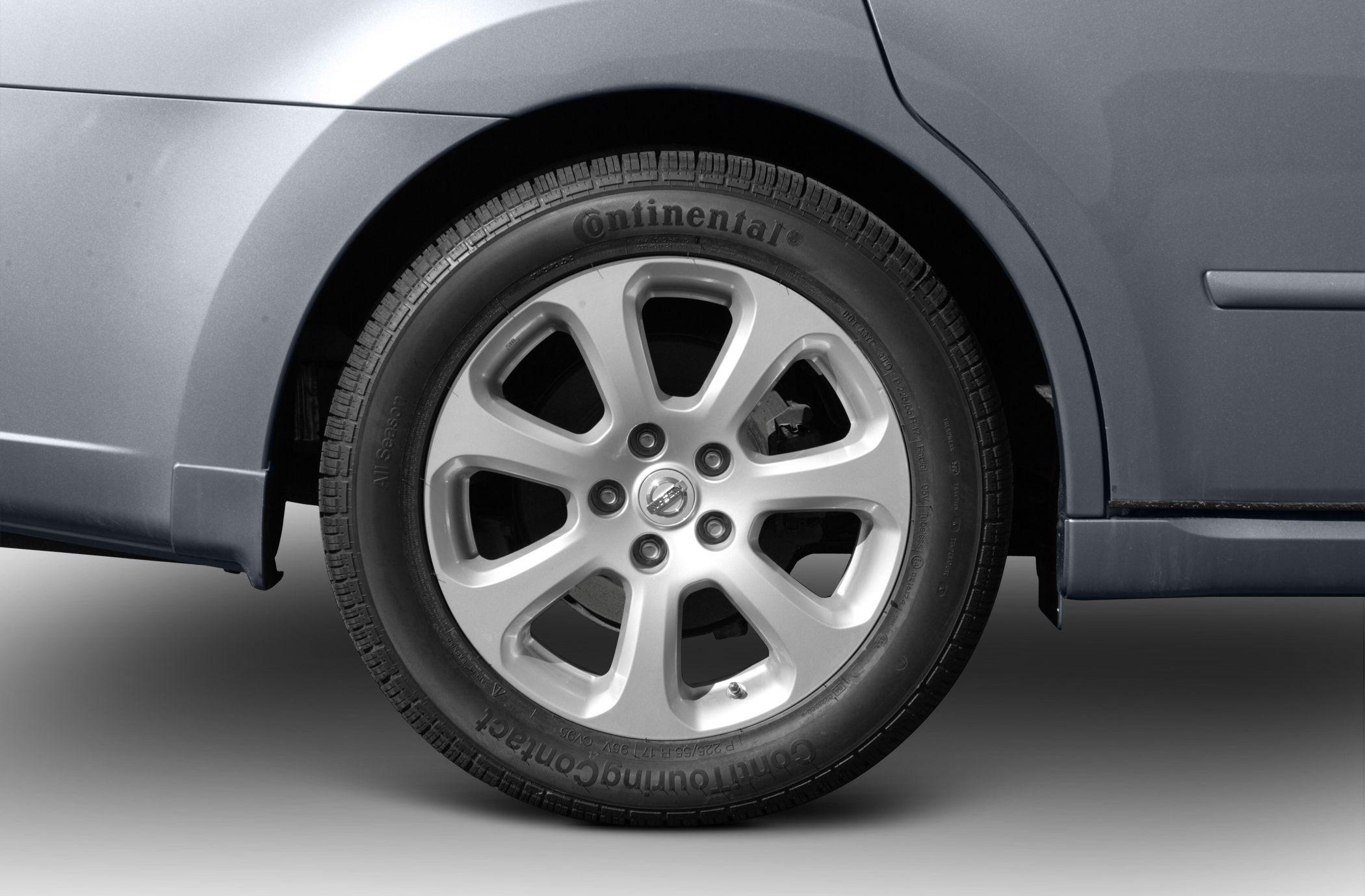 Alloy wheel with Continental tire on vehicle rear side.