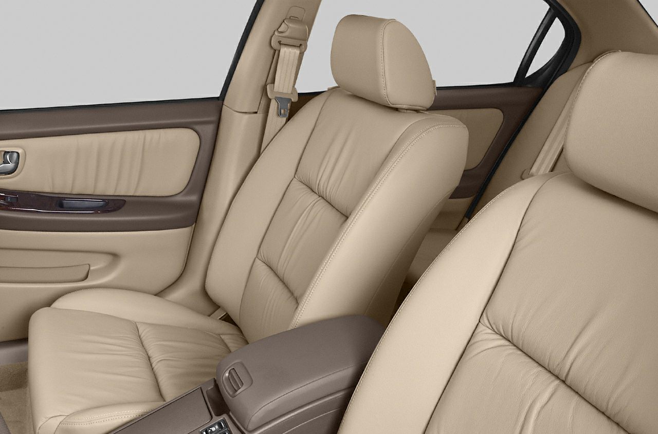 Beige leather front seats and door panel with wood trim