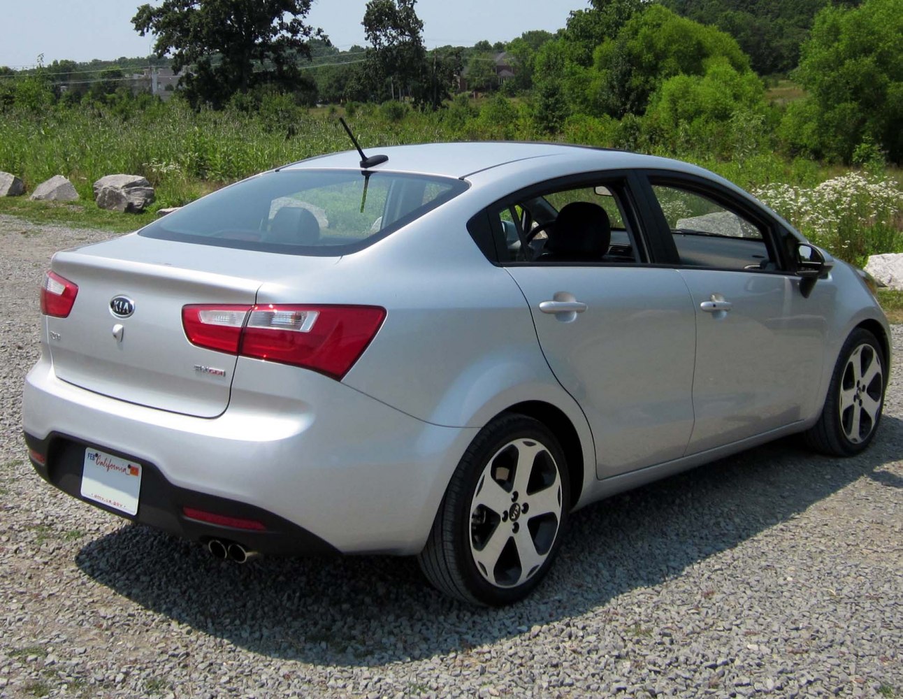 Silver compact sedan rear and side view with distinctive wheels