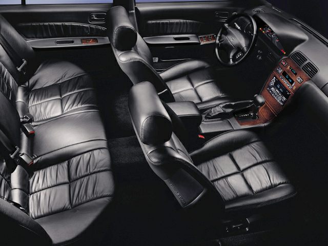 Black leather seats with wood trim dashboard and automatic gearshift