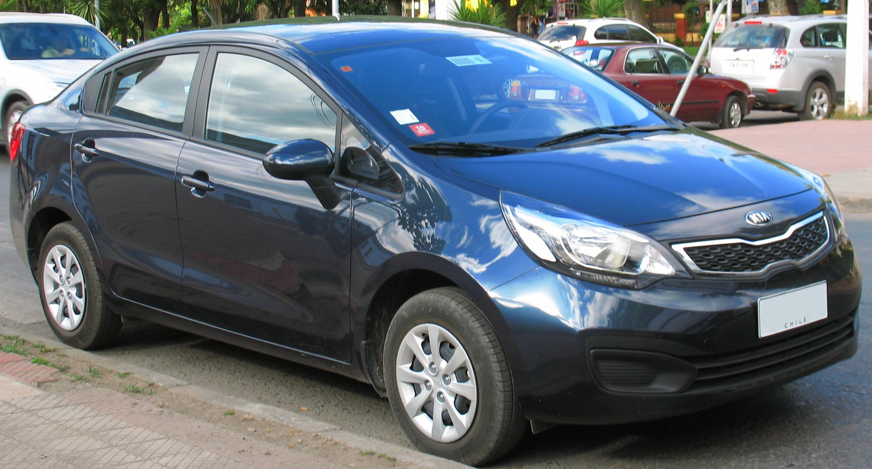 Front side view of sedan with headlights and honeycomb grille