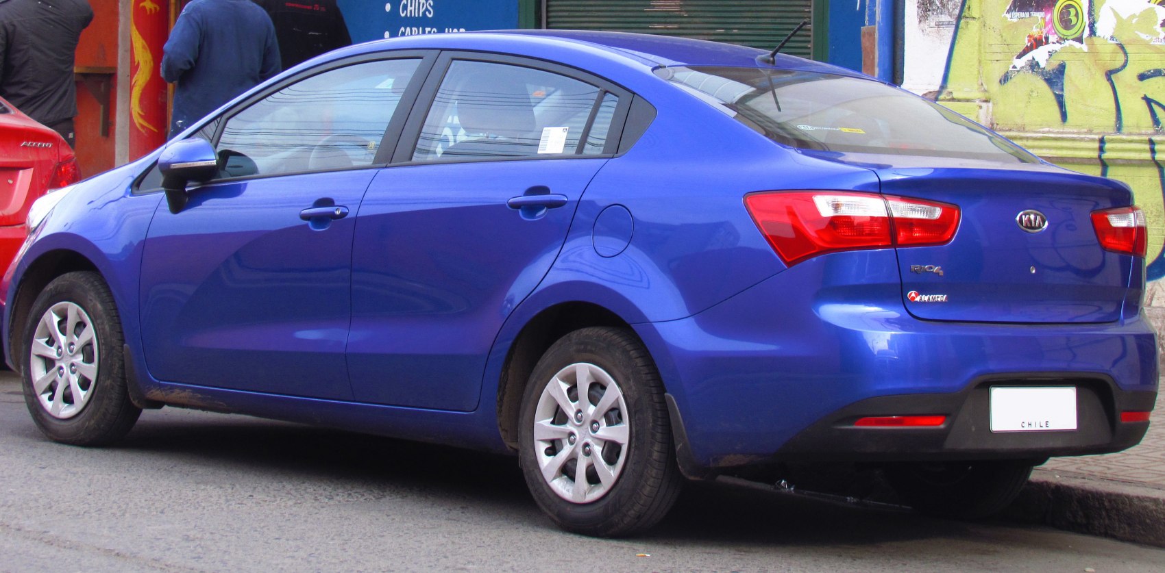 Rear side view of blue sedan with alloy wheels and modern tail lights