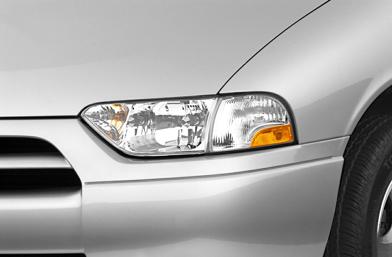 Close-up of front headlight and amber indicator on vehicle front side