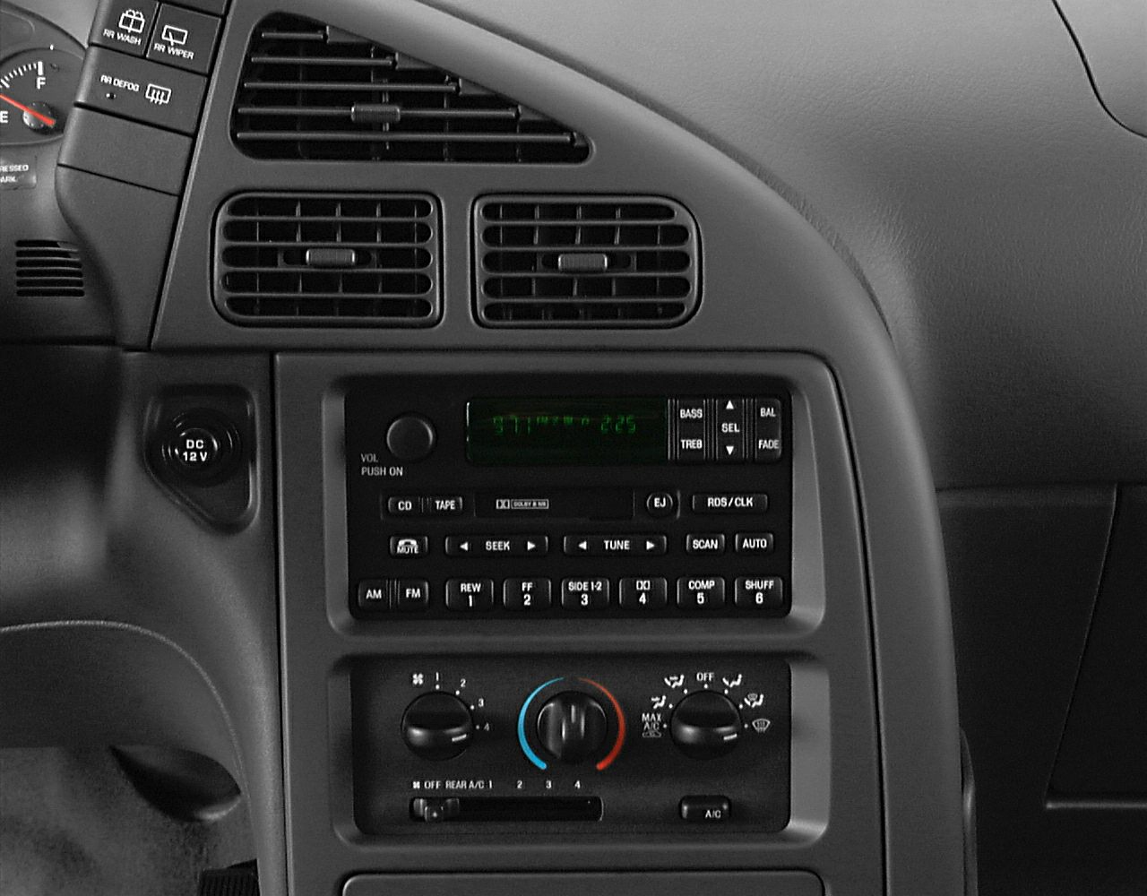 Close-up of sedan dashboard console with audio and climate controls