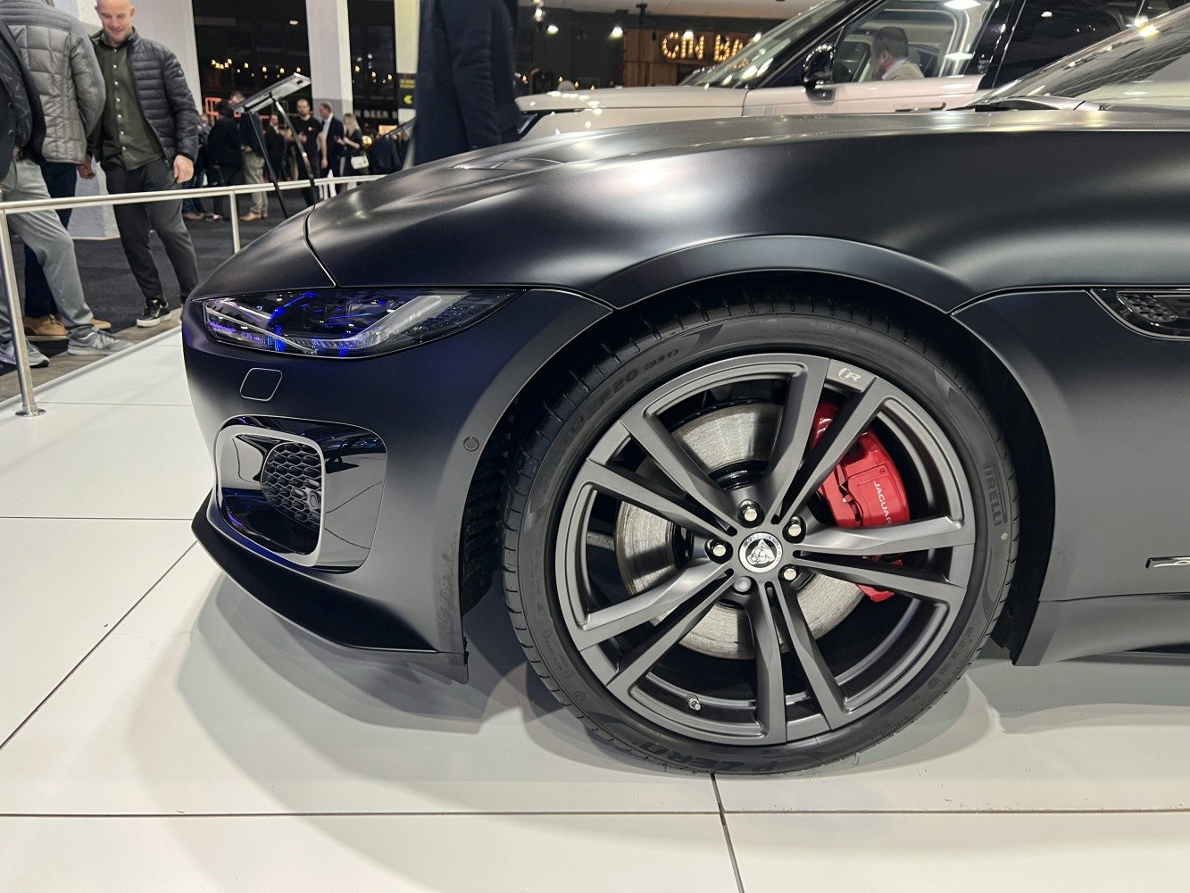 Front wheel and headlight close-up with red brake caliper