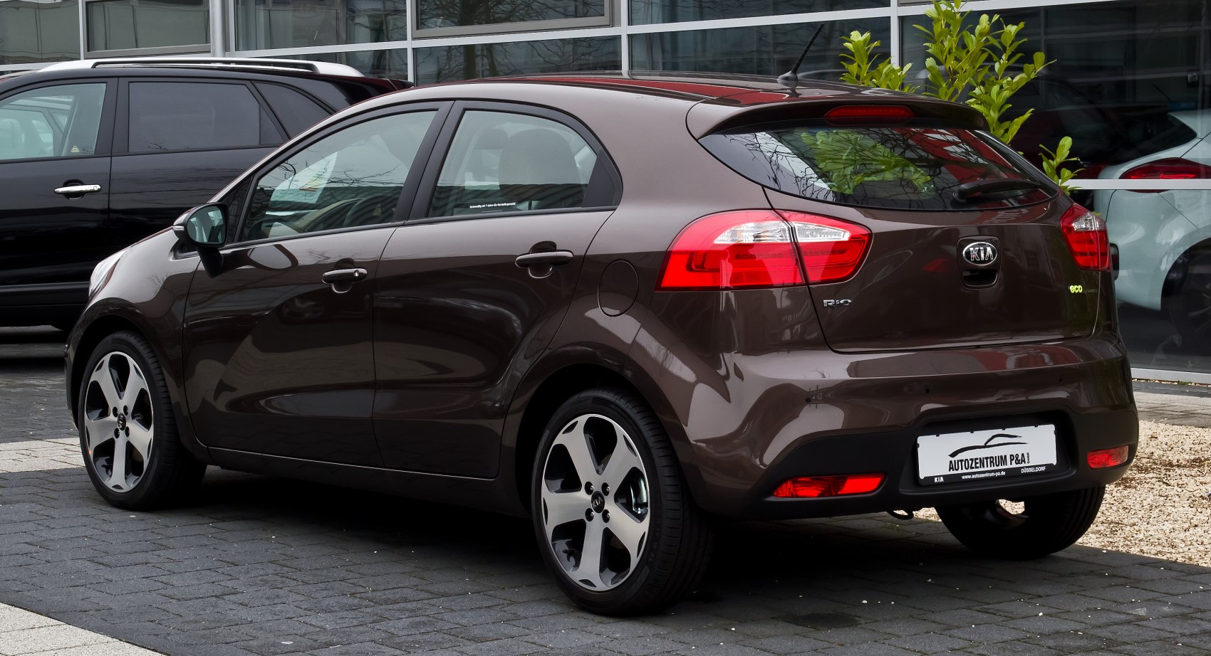 Rear and side view of a brown hatchback with alloy wheels