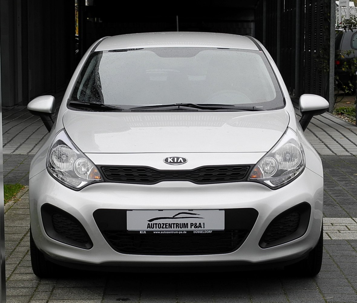 Front view with grille, dual headlights, and bumper air intakes