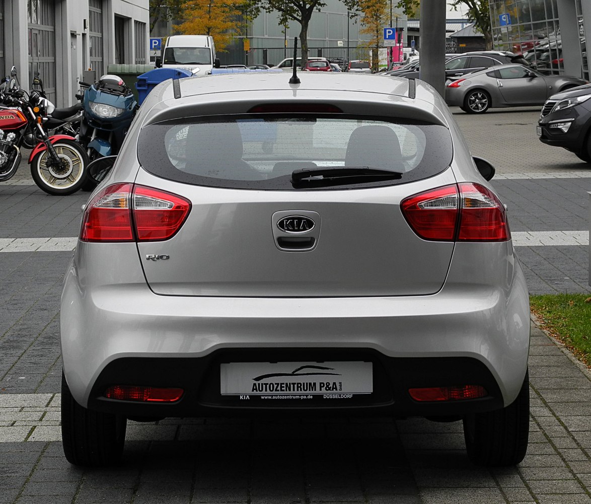 Compact hatchback rear with red tail lights and rear windshield wiper