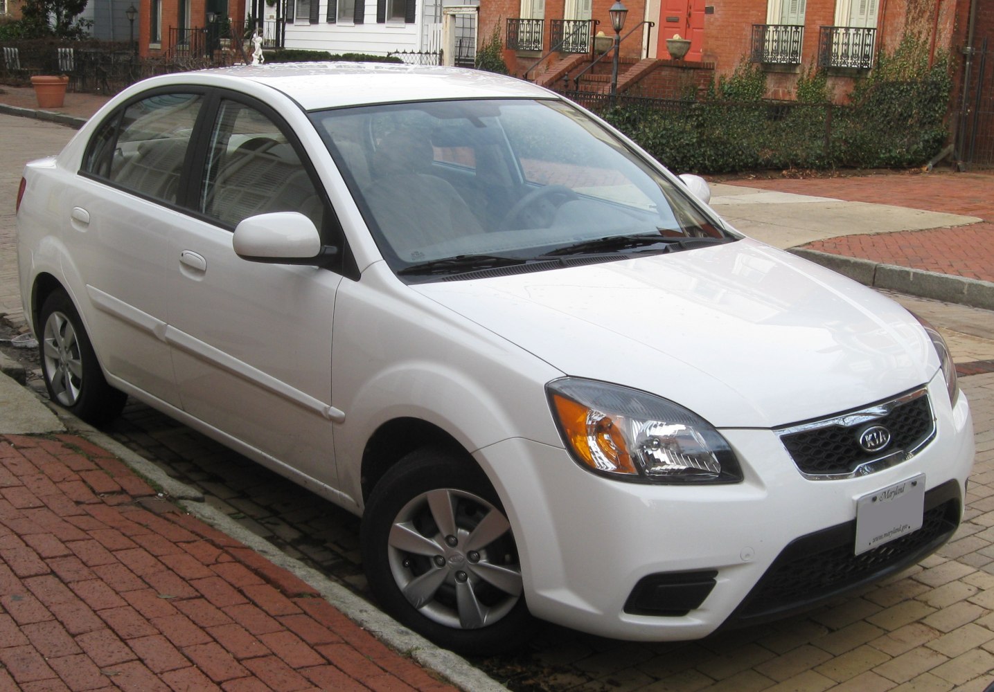 White sedan with modern headlights and alloy wheels