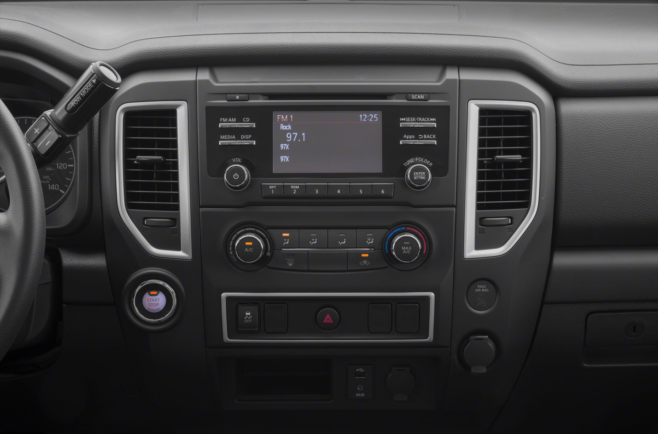 Central infotainment, climate control dials, push-button start, and tow mode shifter