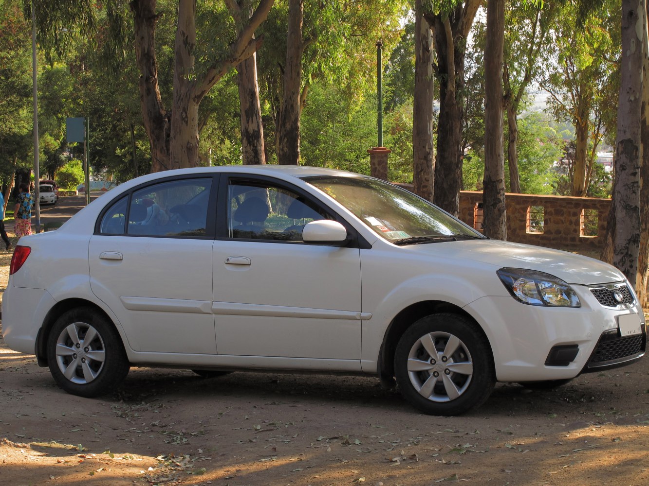 White compact sedan with facelifted front and side profile