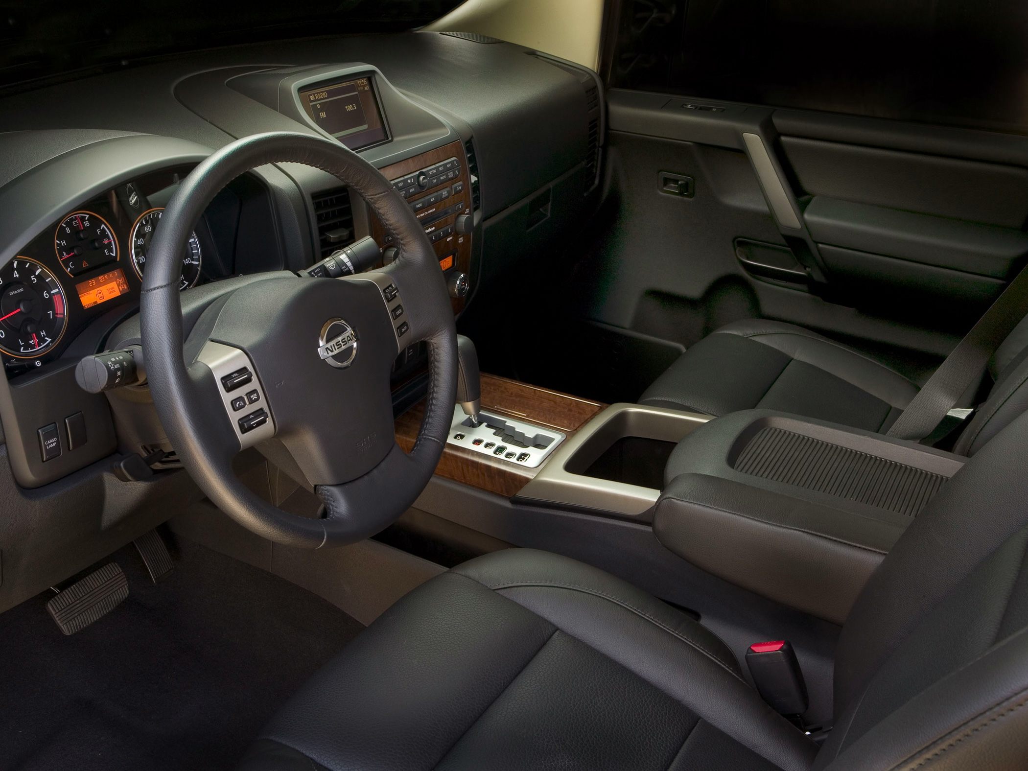 Dashboard, steering wheel, and wood trimmed center console interior