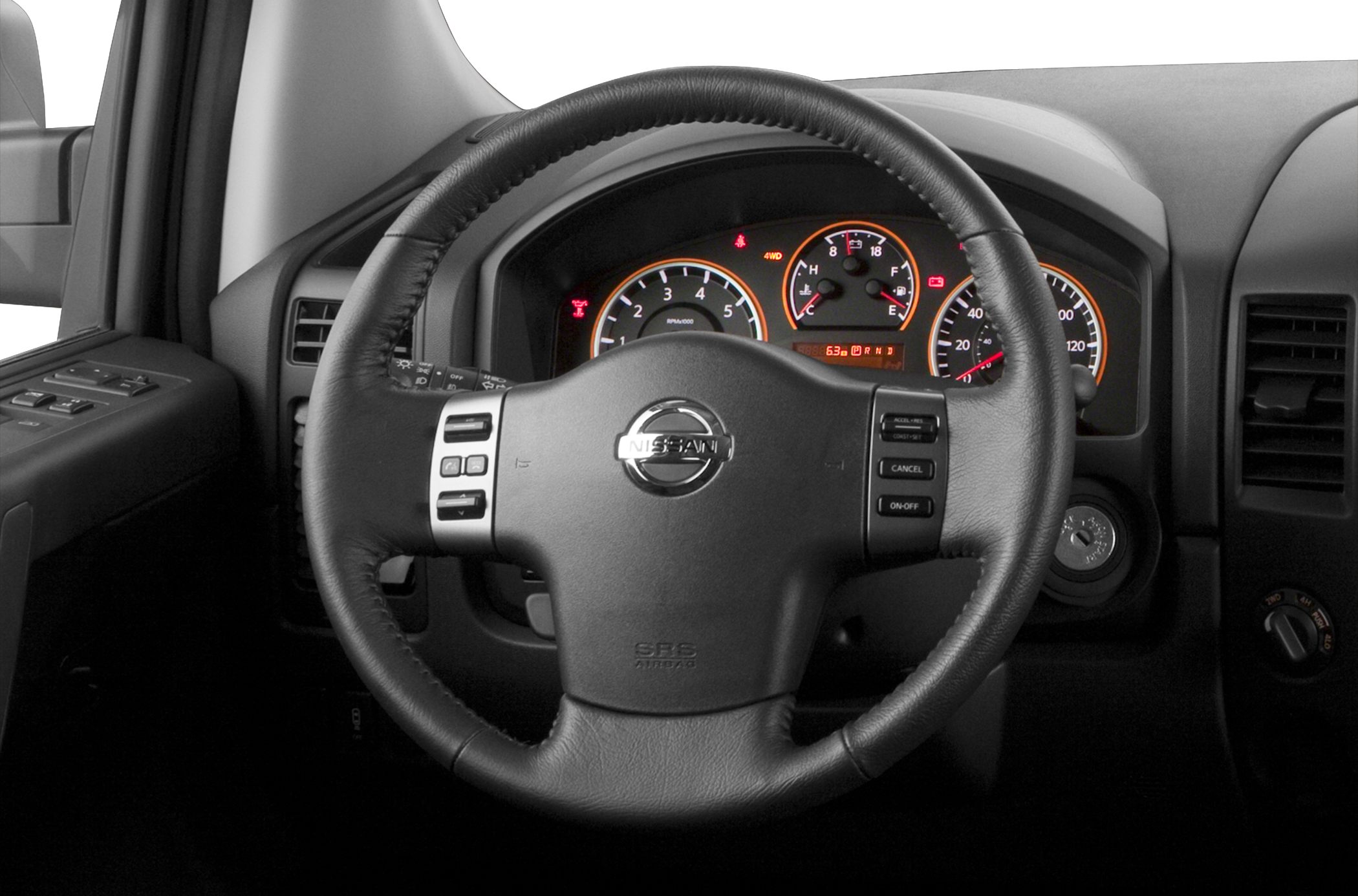 Steering wheel with controls and illuminated dashboard gauges.