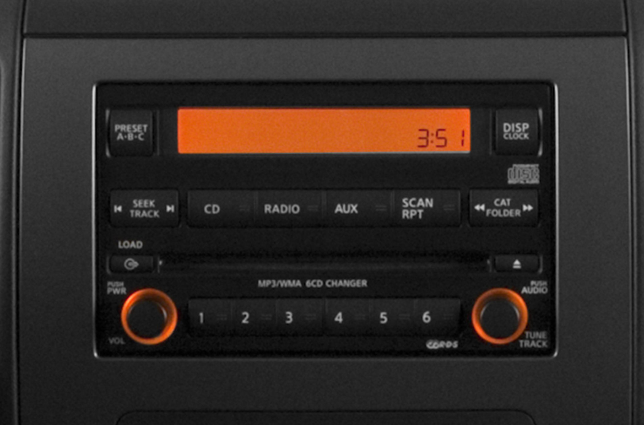 Car stereo radio panel with CD player, radio, aux, and orange backlit knobs.
