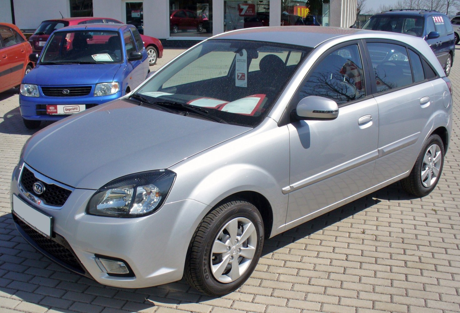 Silver compact hatchback with facelift front, alloy wheels.