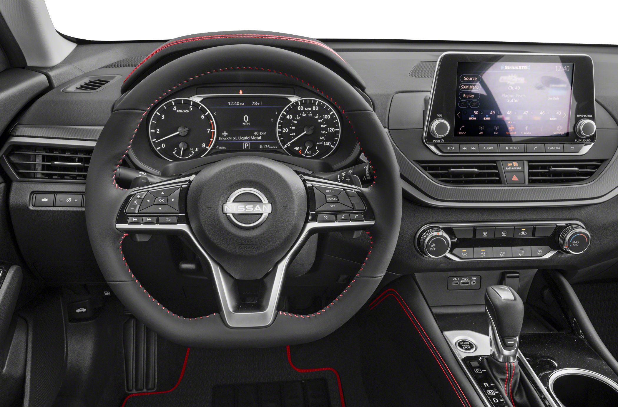 Steering wheel with red stitching, digital instrument cluster, infotainment screen, automatic gear selector
