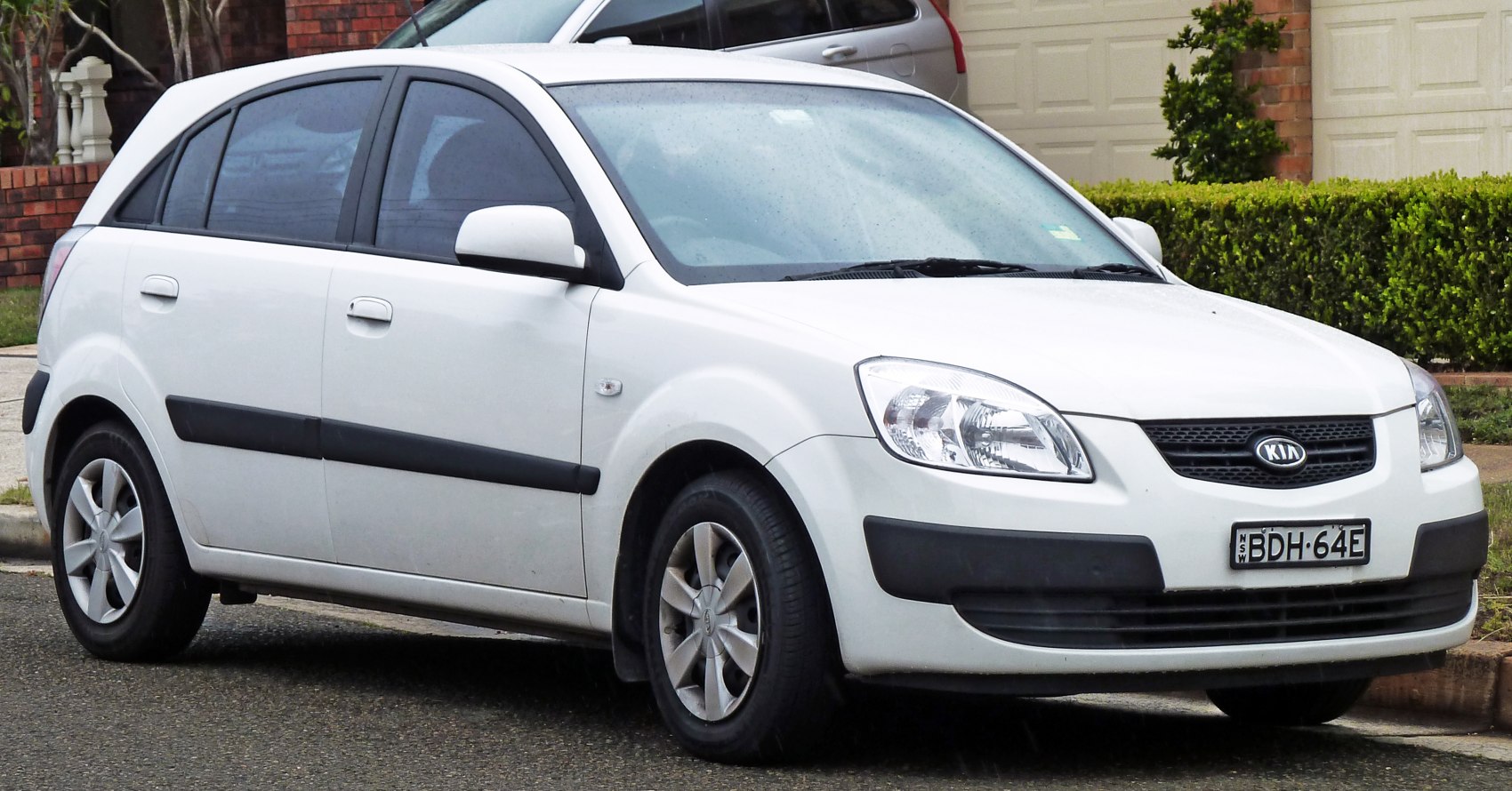 White compact hatchback with alloy wheels and black side trims