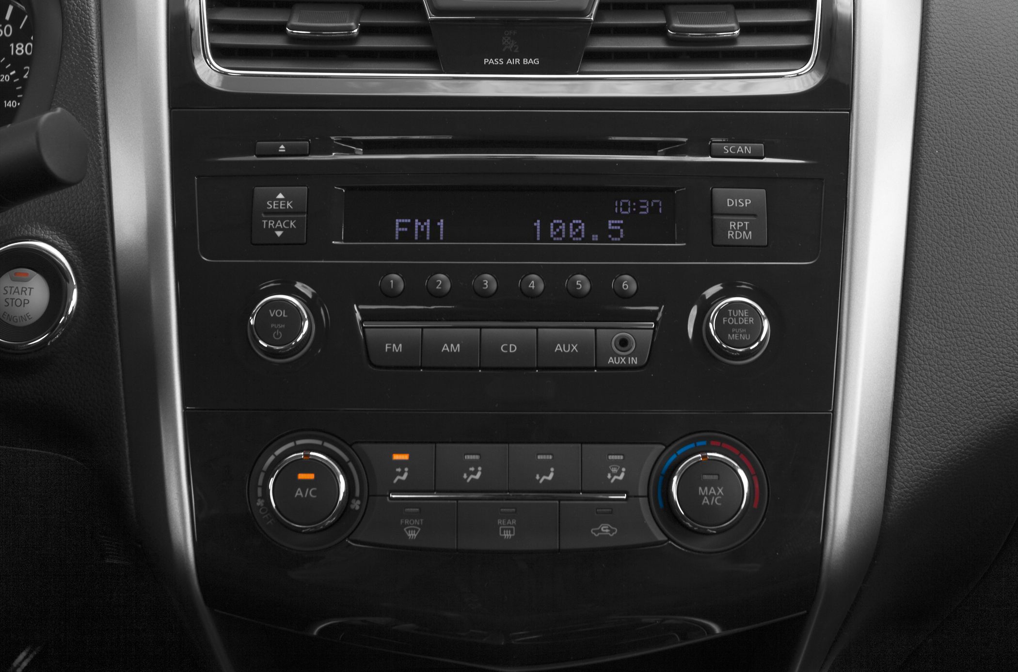 Center console with radio, CD player, AUX input, and climate control knobs