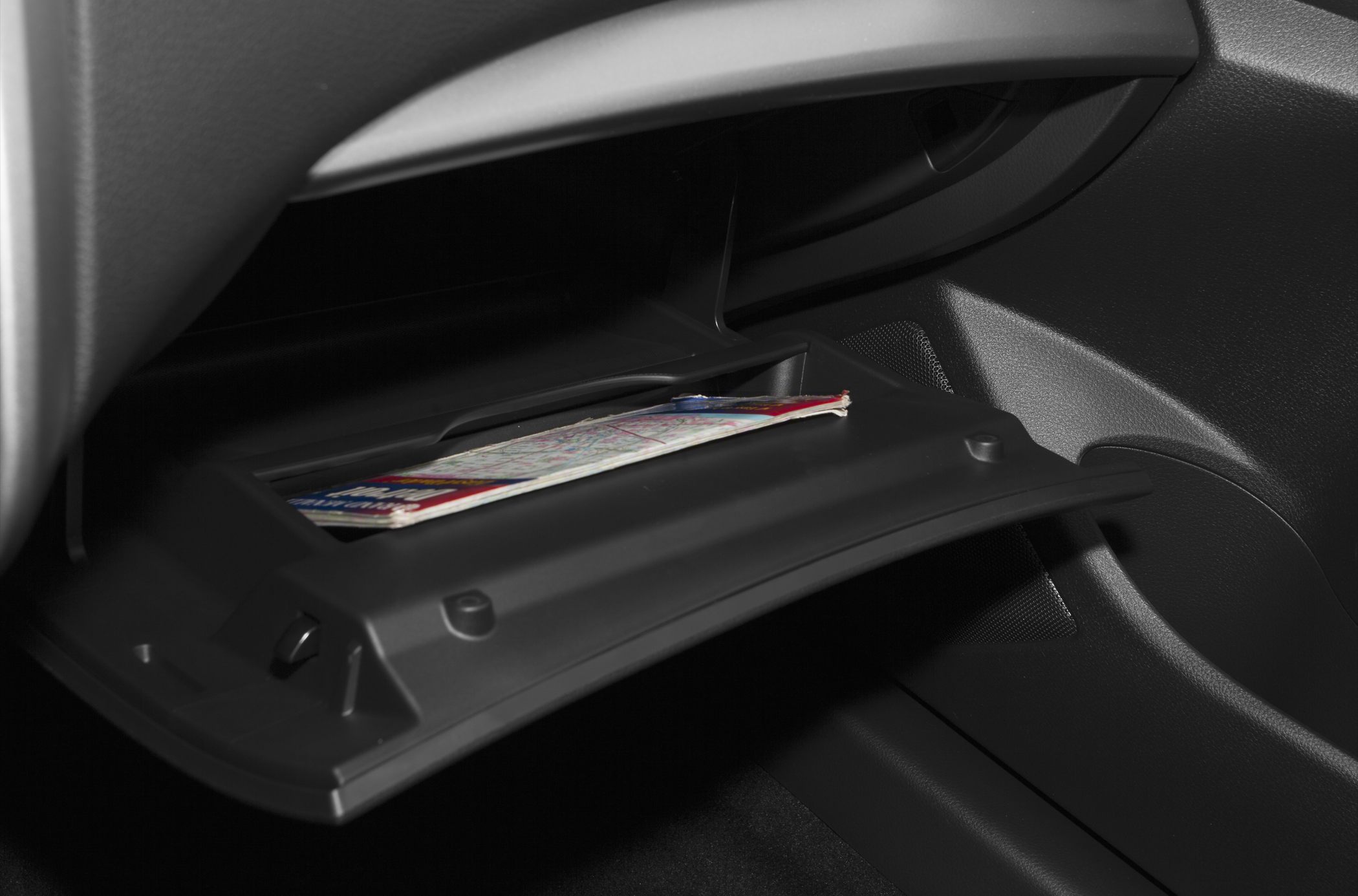 Open glove compartment with map inside