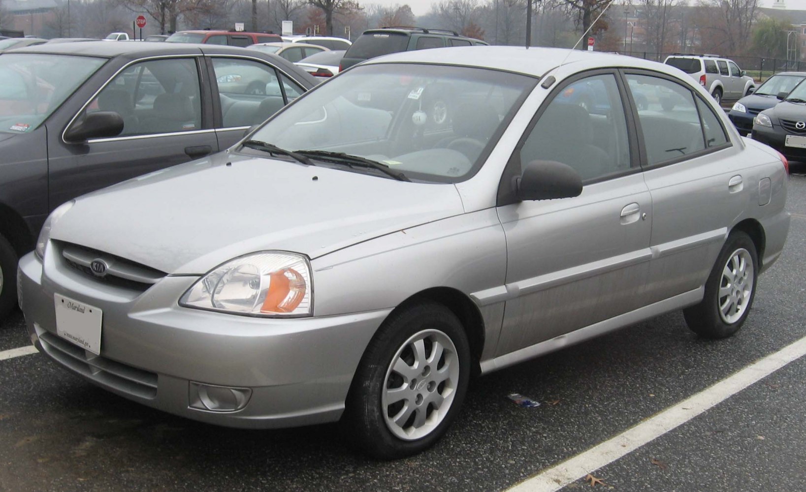 Front and side view of a compact sedan with silver color and alloy wheels
