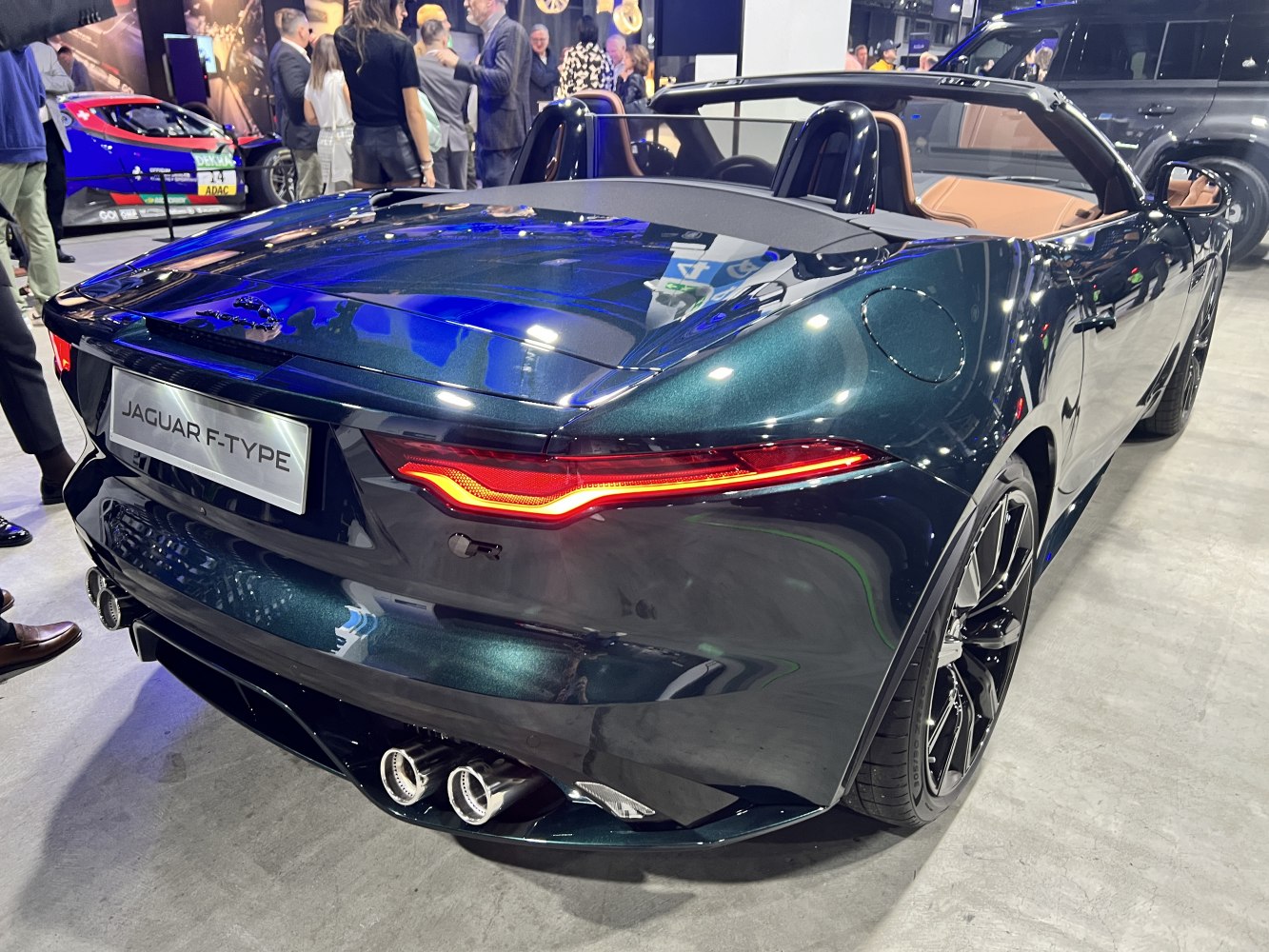 Convertible sports car rear with sleek taillights and quad exhaust tips