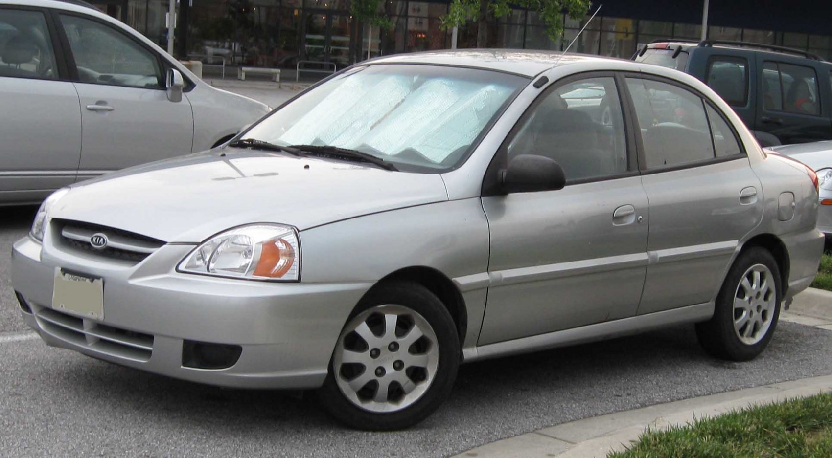 Compact silver four-door sedan with distinctive front grille and headlights