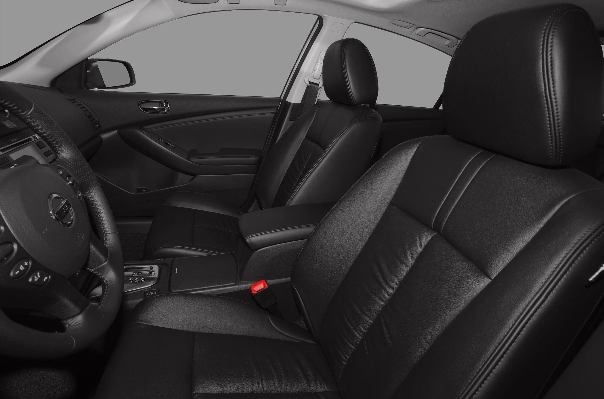 Black leather front seats and steering wheel inside a sedan interior