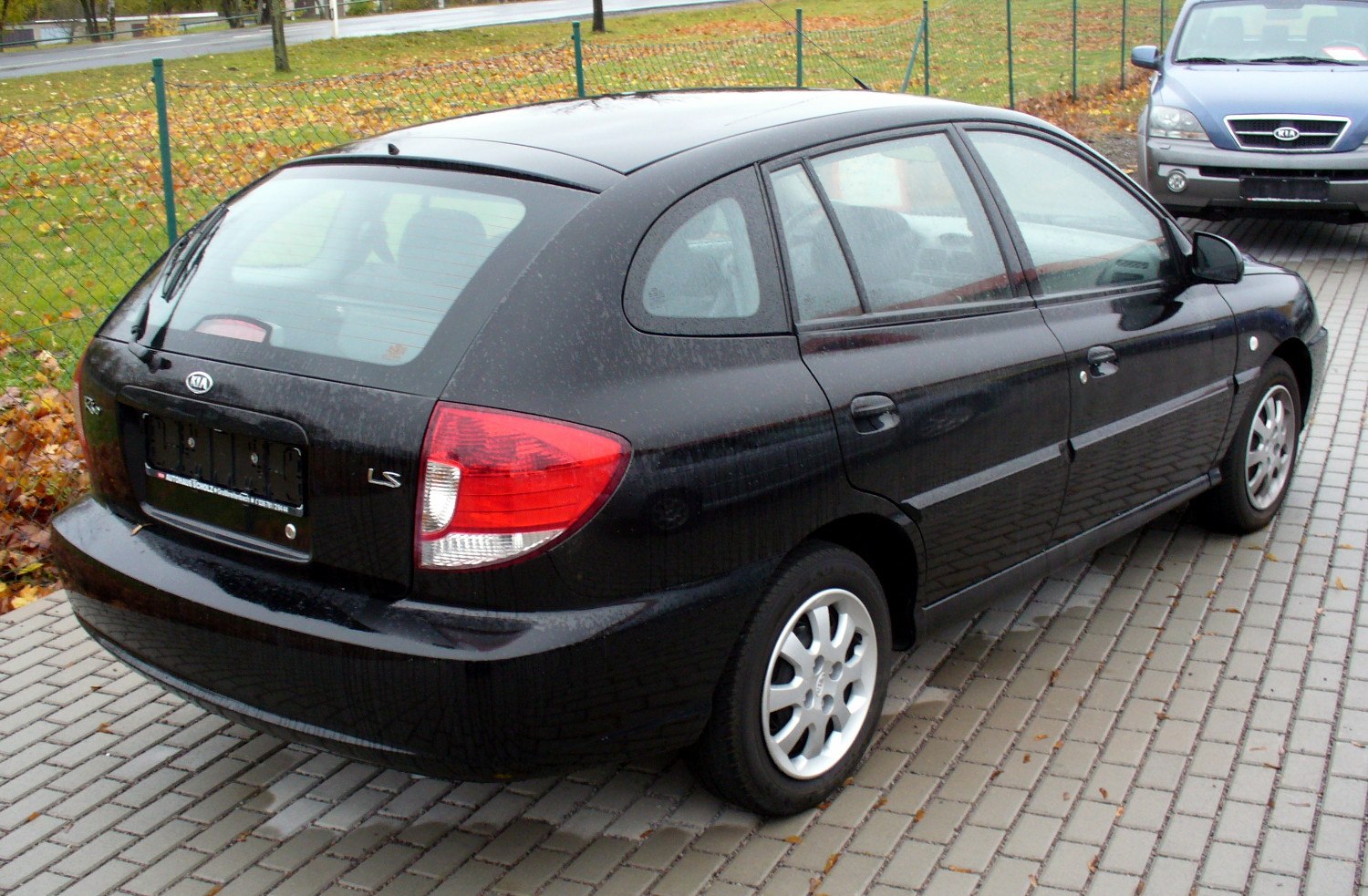 Black Kia hatchback showing rear and side design details.