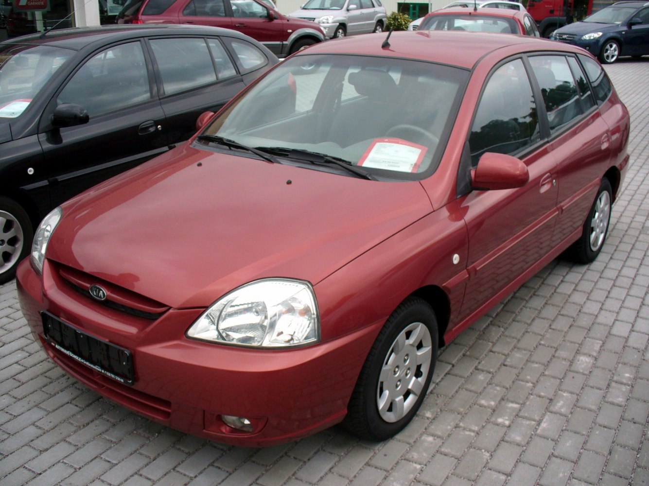 Front and side view of 2002 hatchback with prominent headlights and aerodynamic shape