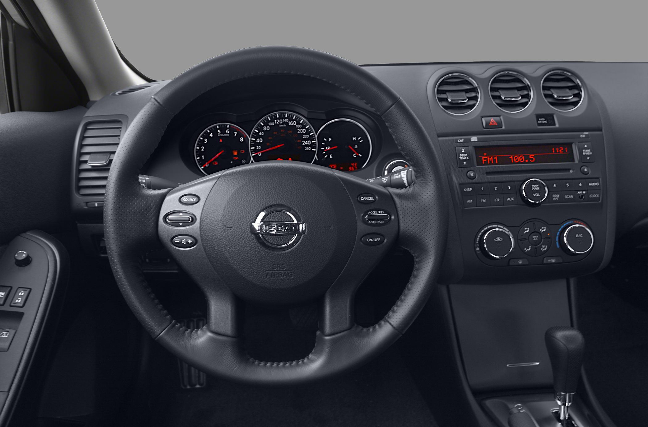 Dashboard, steering wheel with control buttons, central console with air vents and audio system