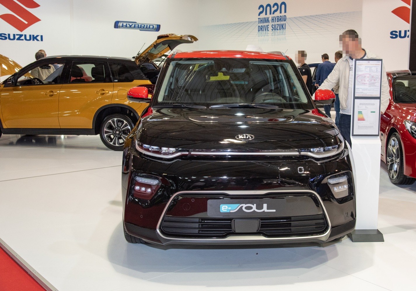 Front view of black electric vehicle with red roof and LED headlights