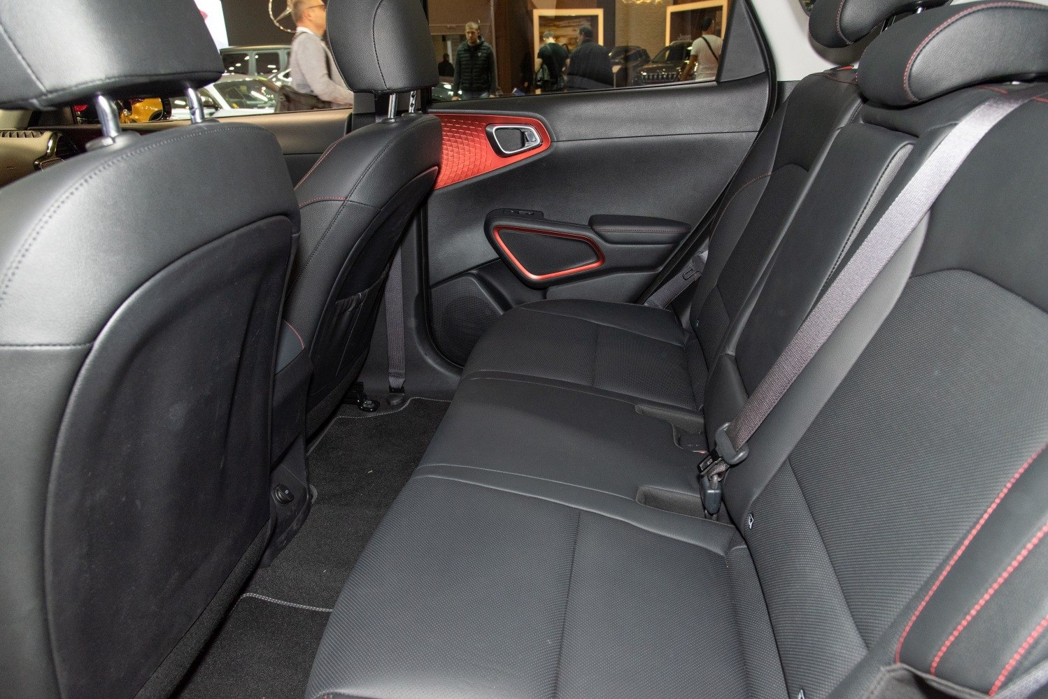 Rear seats with black leather and red stitching details