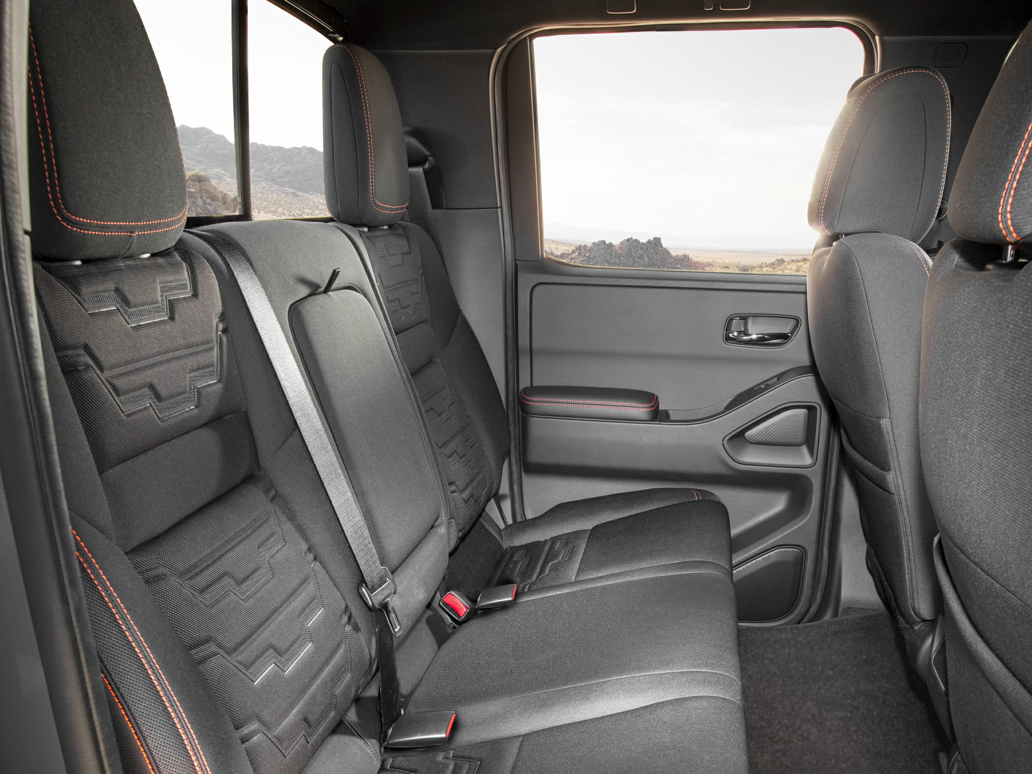Rear seat with detailed upholstery and seat belts in a pickup truck cabin