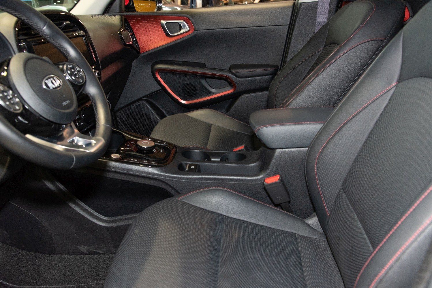Black seats with red stitching, modern door panel and center console design
