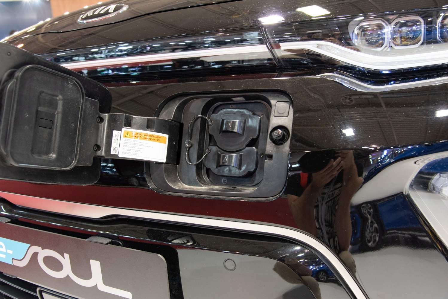 Electric charging port and LED headlight close-up on vehicle front