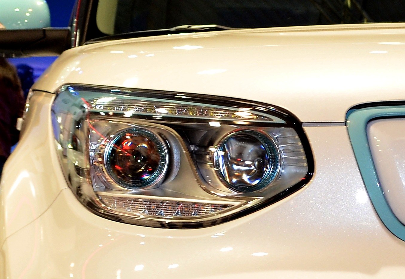 Close-up of dual projector headlights with sleek housing.