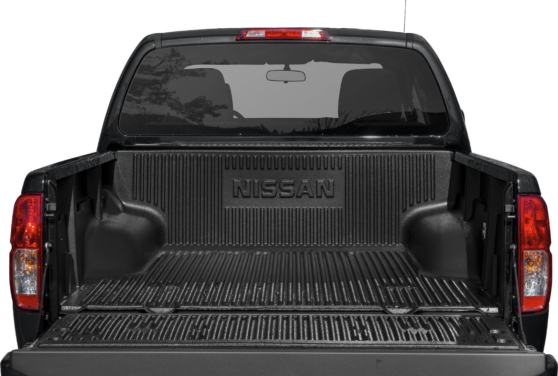 Open truck bed with protective liner and tail lights in rear view.