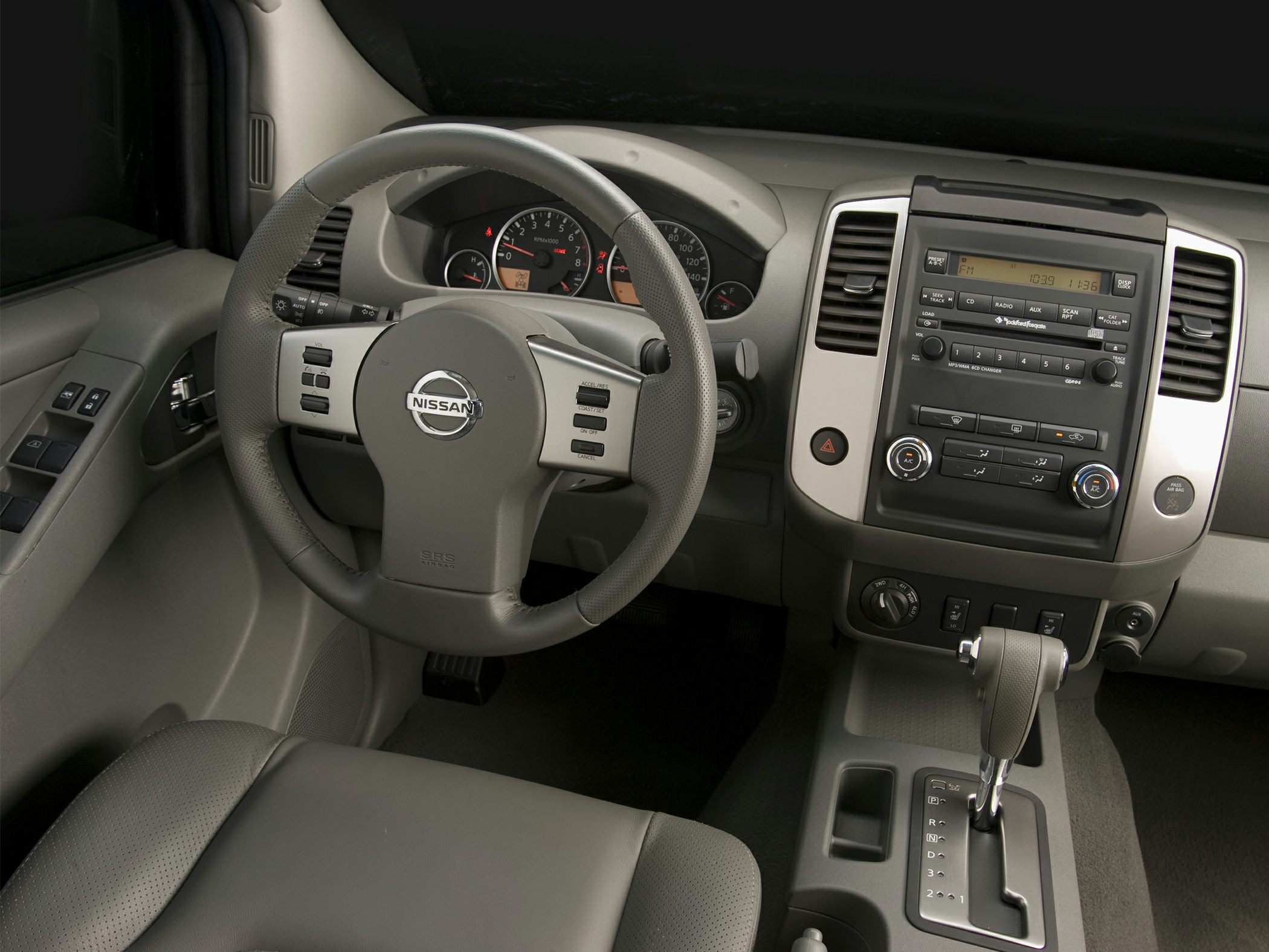 Steering wheel and dashboard with control panels and gear shift