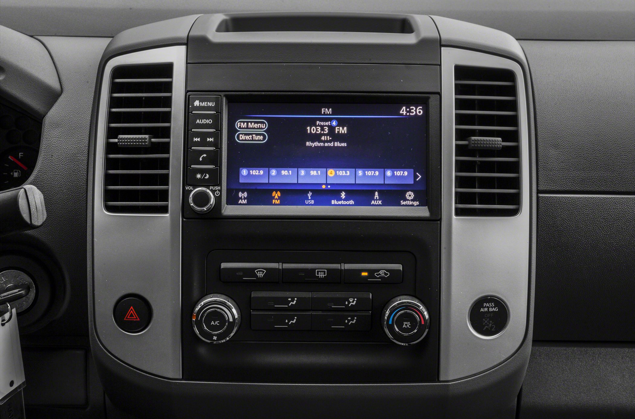 Digital infotainment screen with radio and climate control knobs