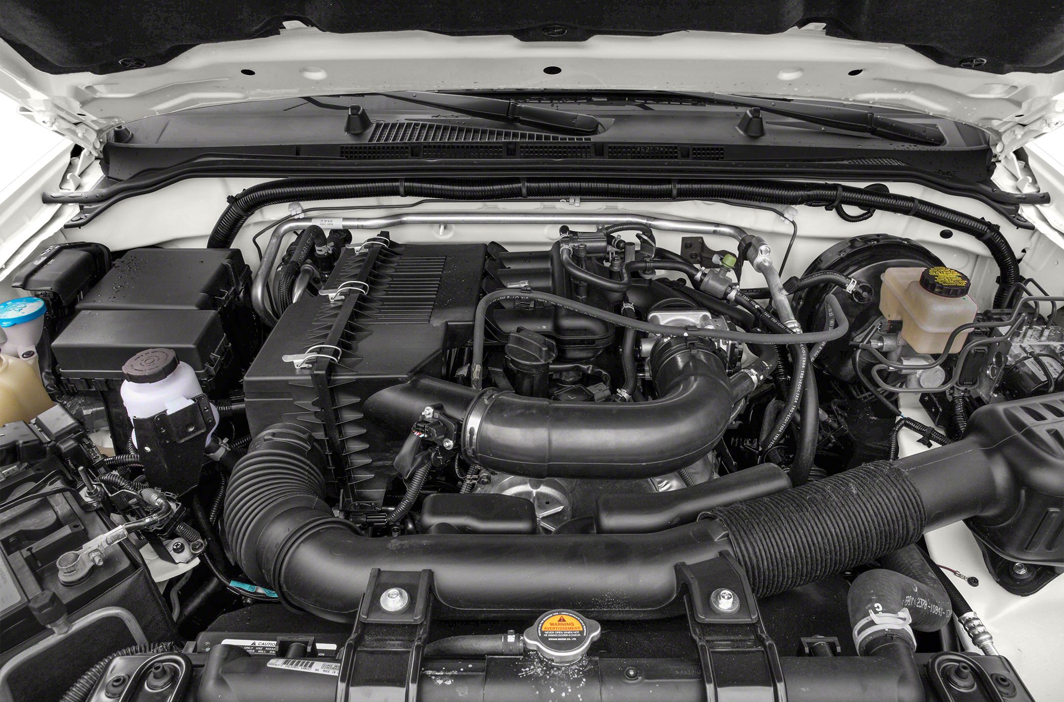 Engine bay with air intake system and coolant reservoir