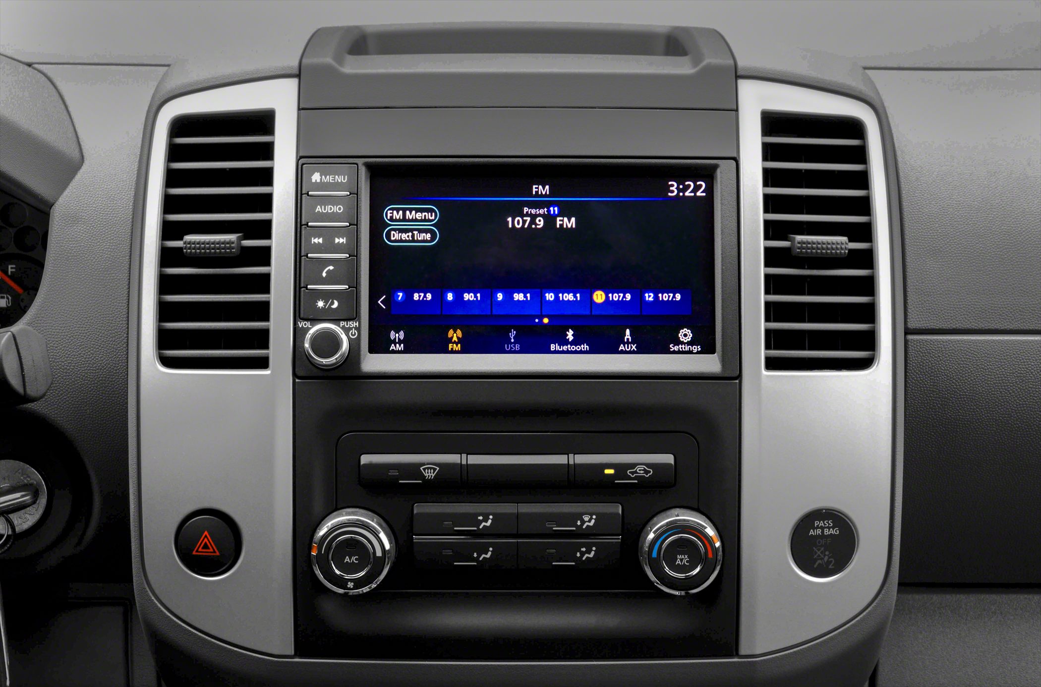 Infotainment system screen and climate control knobs on a car dashboard
