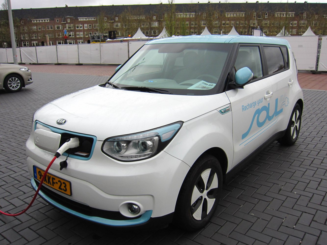Front view of electric compact SUV with charging port in use.