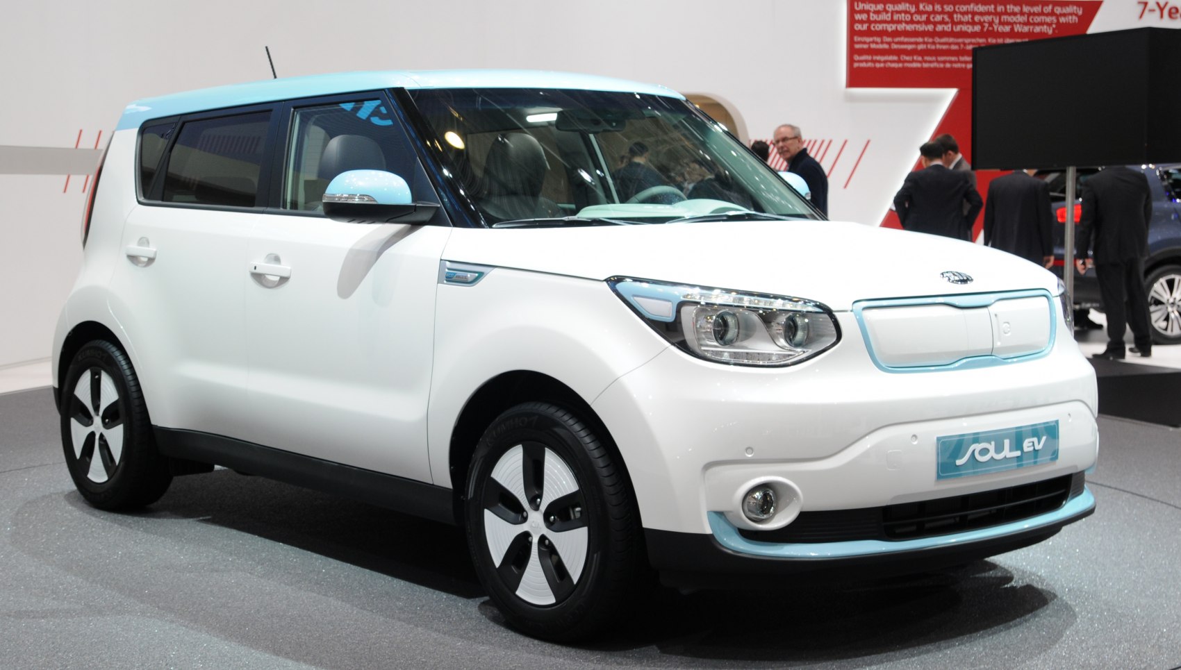 Front and side view of white electric vehicle with blue trim and aerodynamic wheels