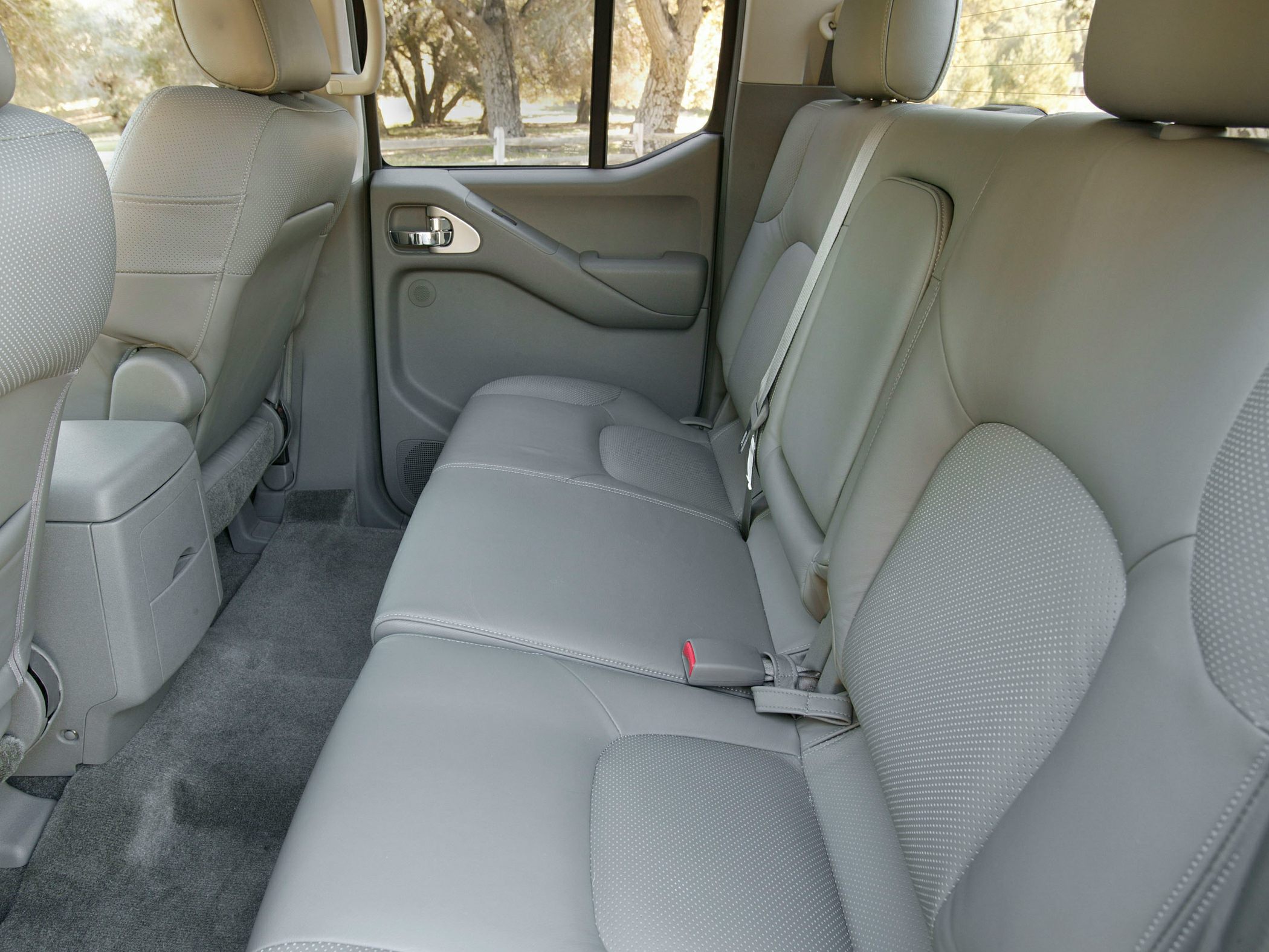 Rear seating area with gray leather upholstery and spacious legroom
