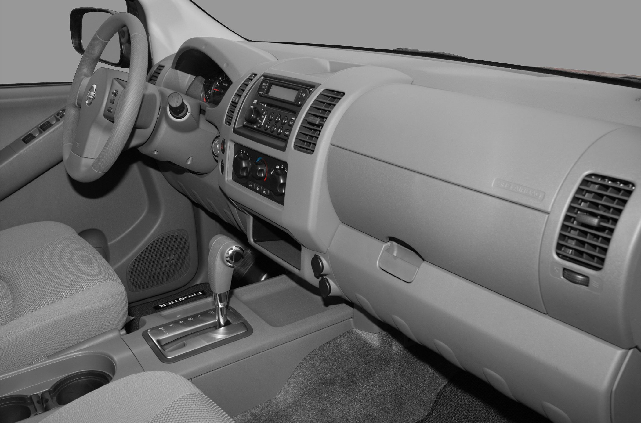 Dashboard and center console with automatic gear shift, air vents, and radio system.