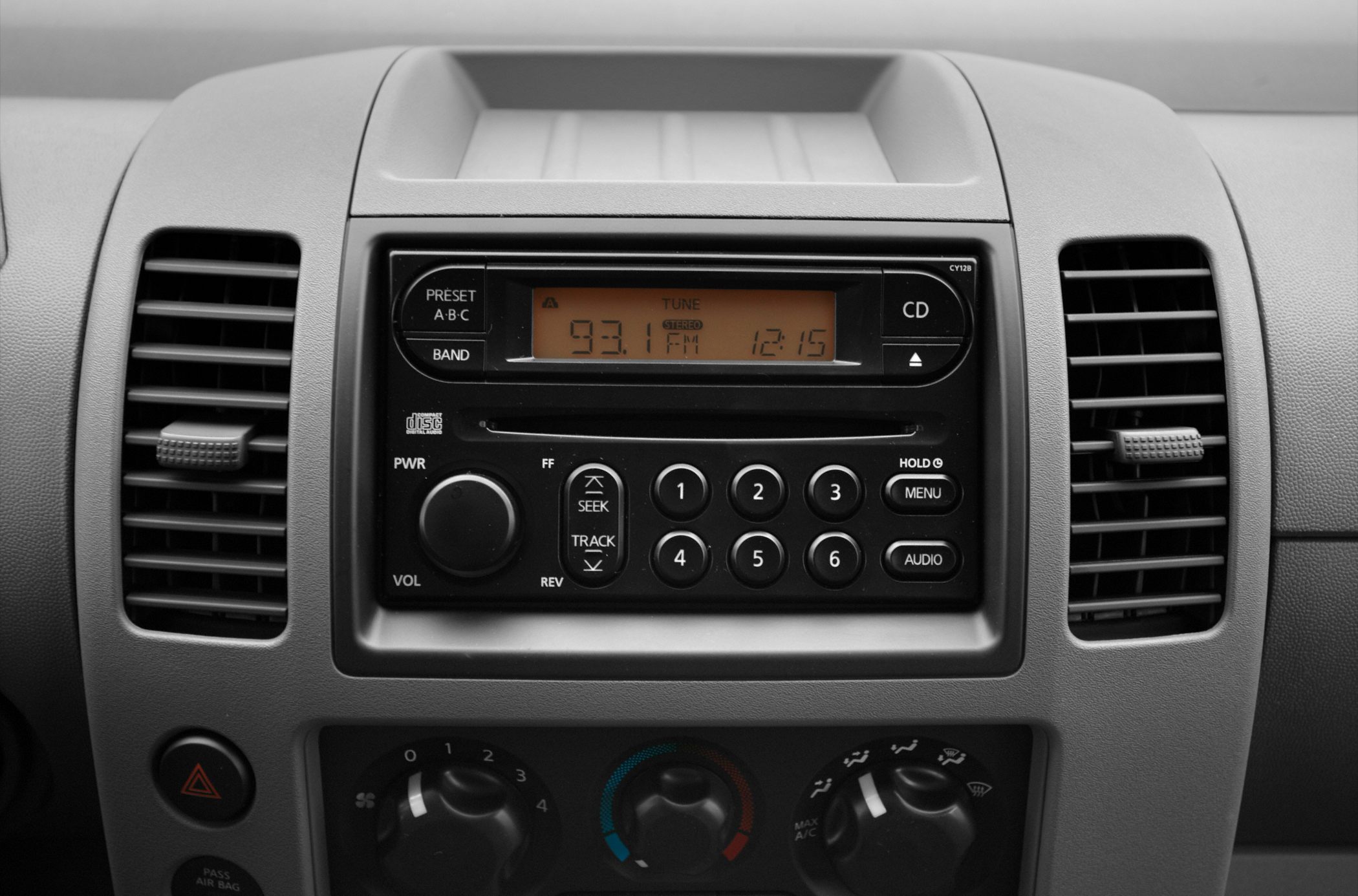 Car radio and climate control panel with buttons and dials