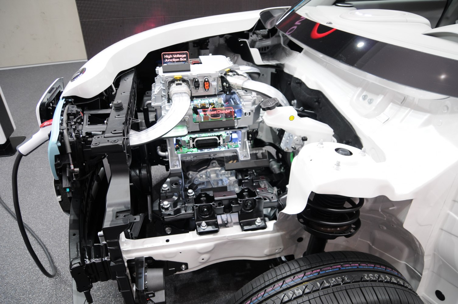 Electric motor assembly and front suspension coil spring