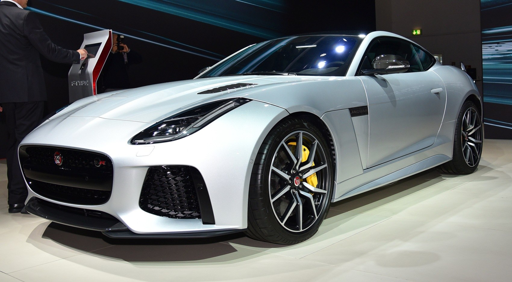 Front and side view of sports car with yellow brake calipers and mesh grille