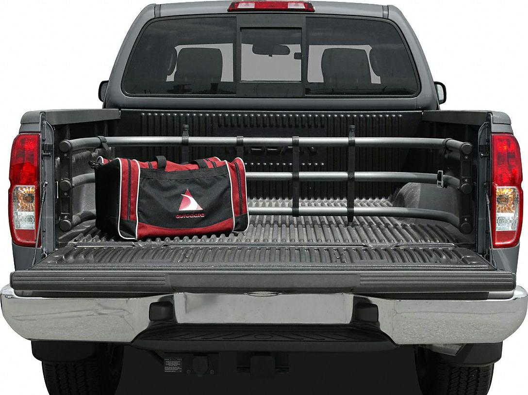 Open pickup bed with cargo divider bar and soft side bag