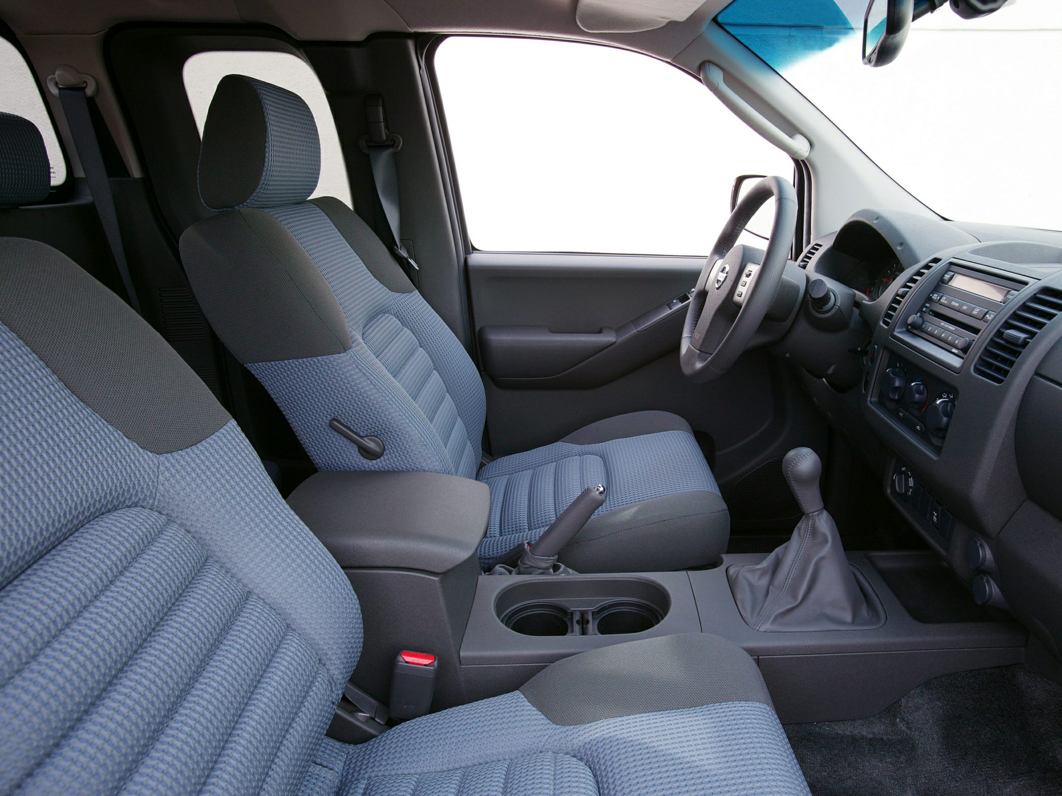Manual transmission and fabric seats interior with center console and dashboard.